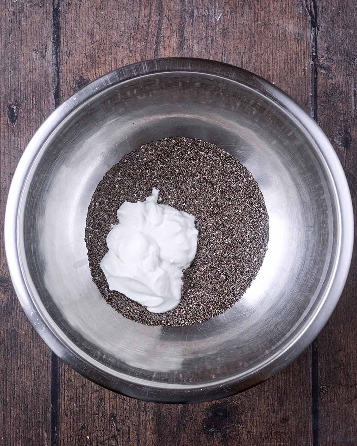 Chia seeds and yogurt in a large mixing bowl.