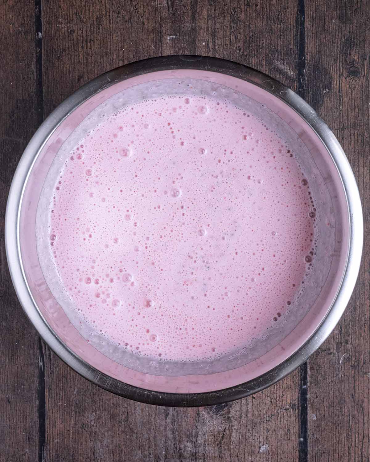 Strawberry milk poured into the mixing bowl.