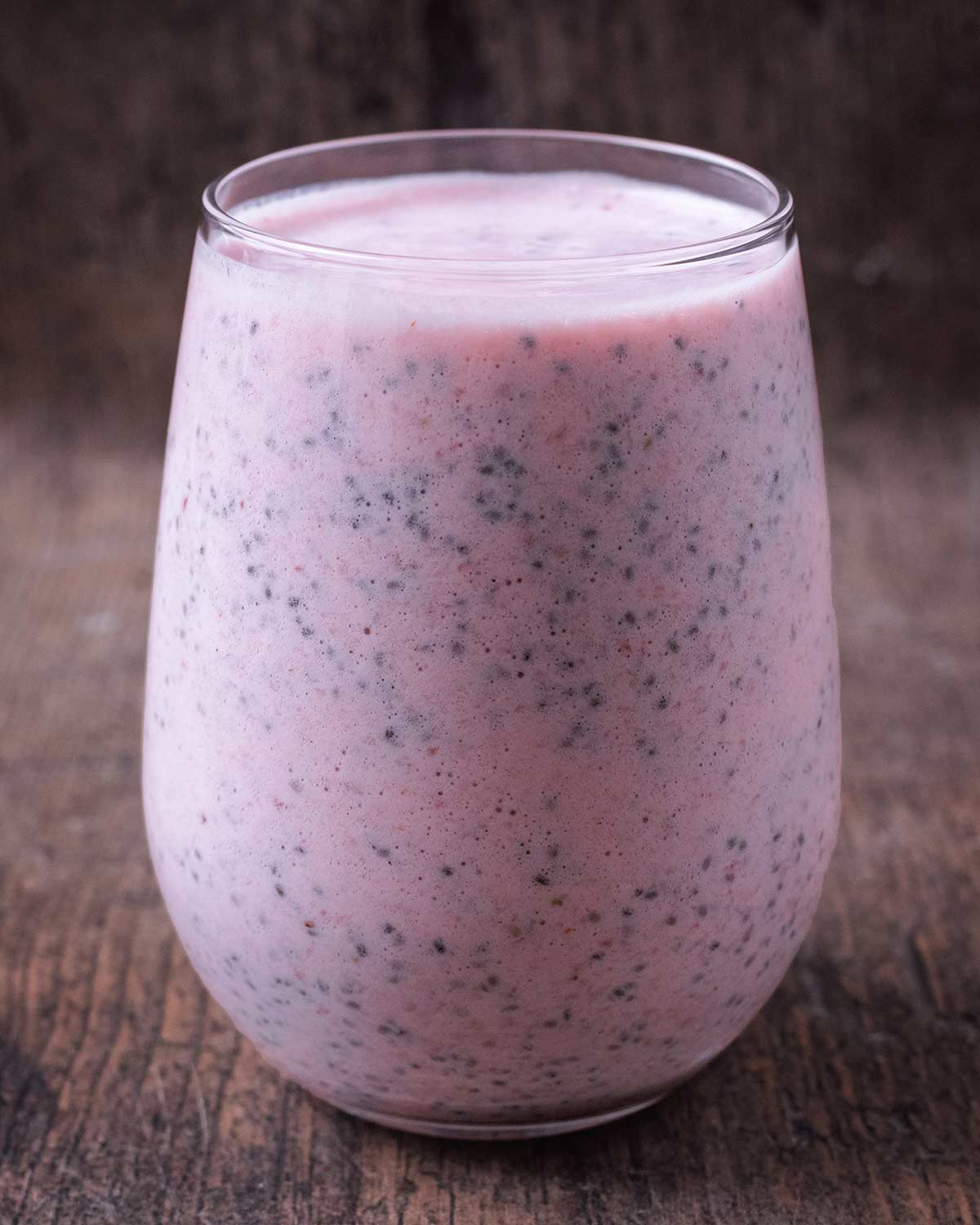 Strawberry chia seed pudding in a tall serving glass.