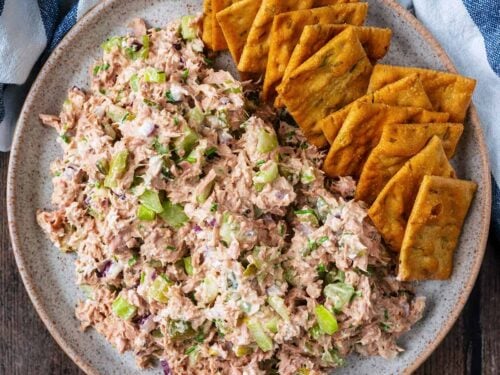 Cottage cheese tuna salad on a plate with some square crackers.