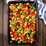 Halloumi tray bake on a wooden surface.
