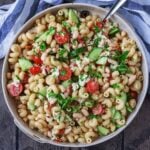 A large serving dish full of Summer pasta salad.