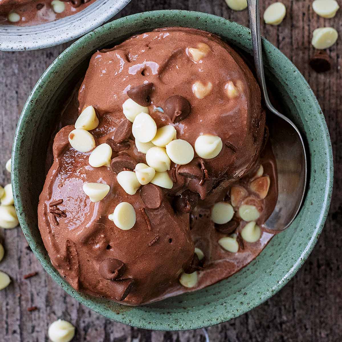 Two scoops of chocolate cottage cheese ice cream in a green bowl.