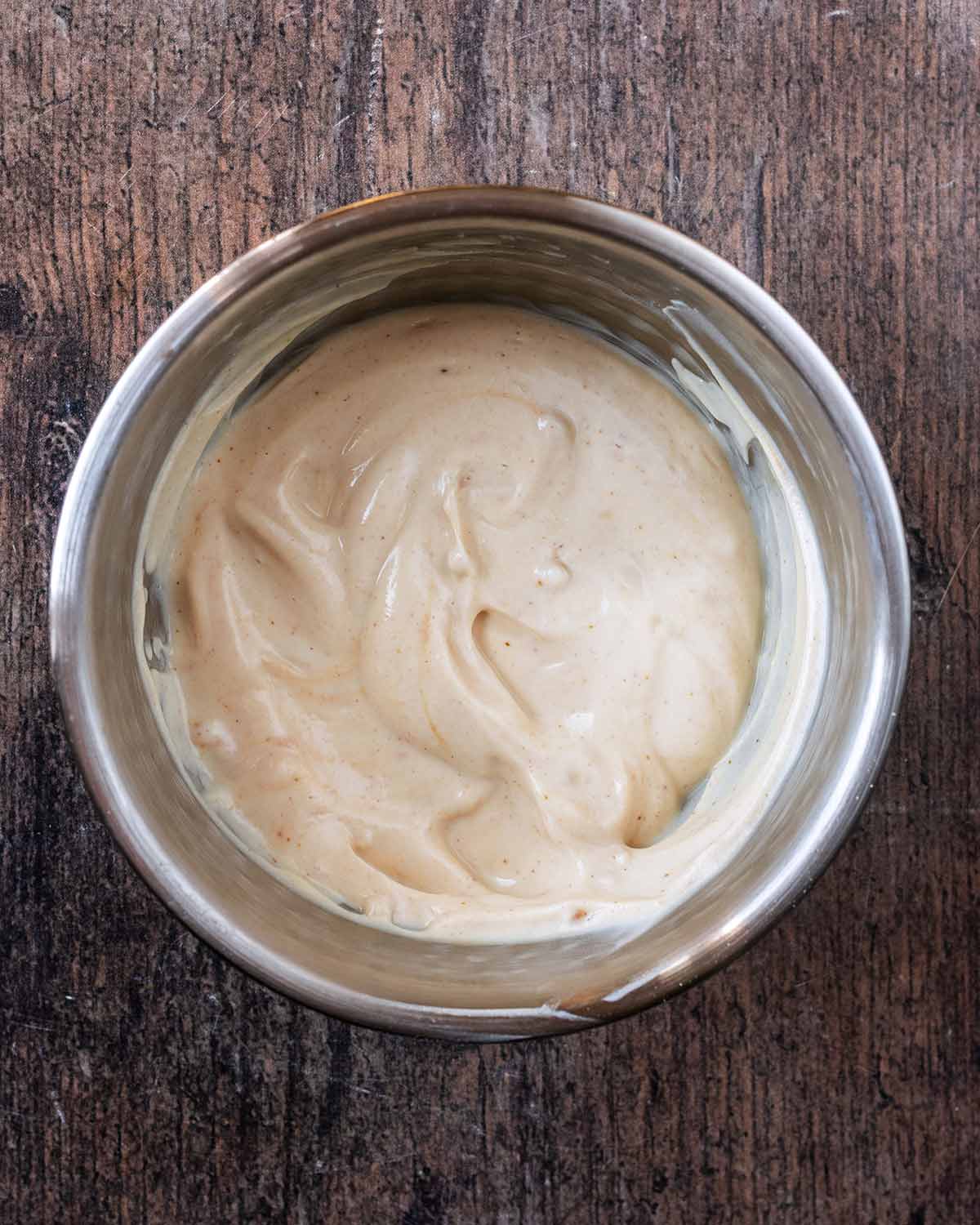 A bowl of yogurt and peanut butter mixed together.