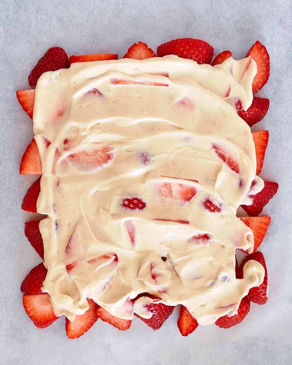 The peanut yogurt spread over the strawberries.