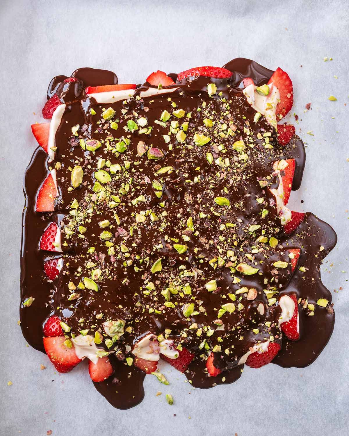 Melted chocolate and crushed pistachios added on top of the yogurt.