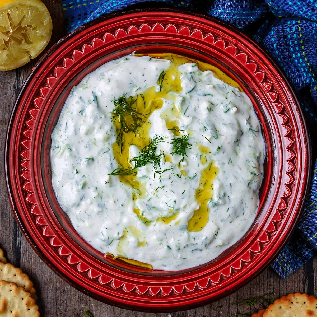 A red bowl full of cottage cheese tzatziki.