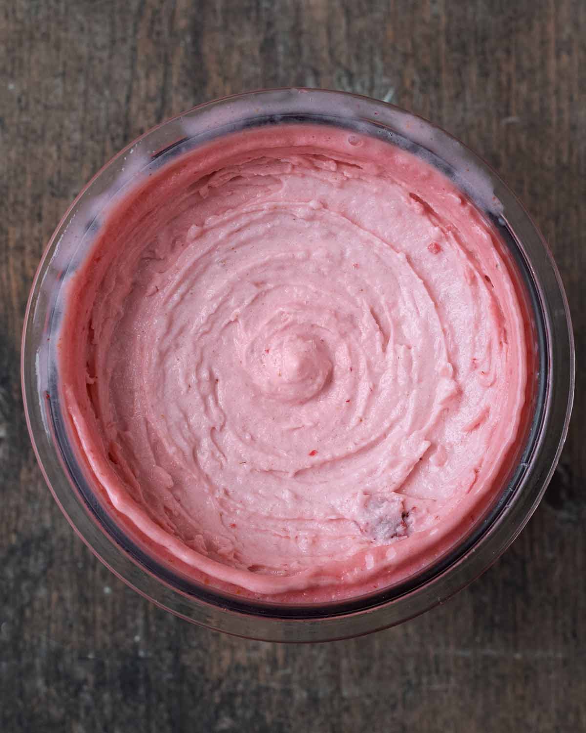 Creamy strawberry ice cream in the pint tub.