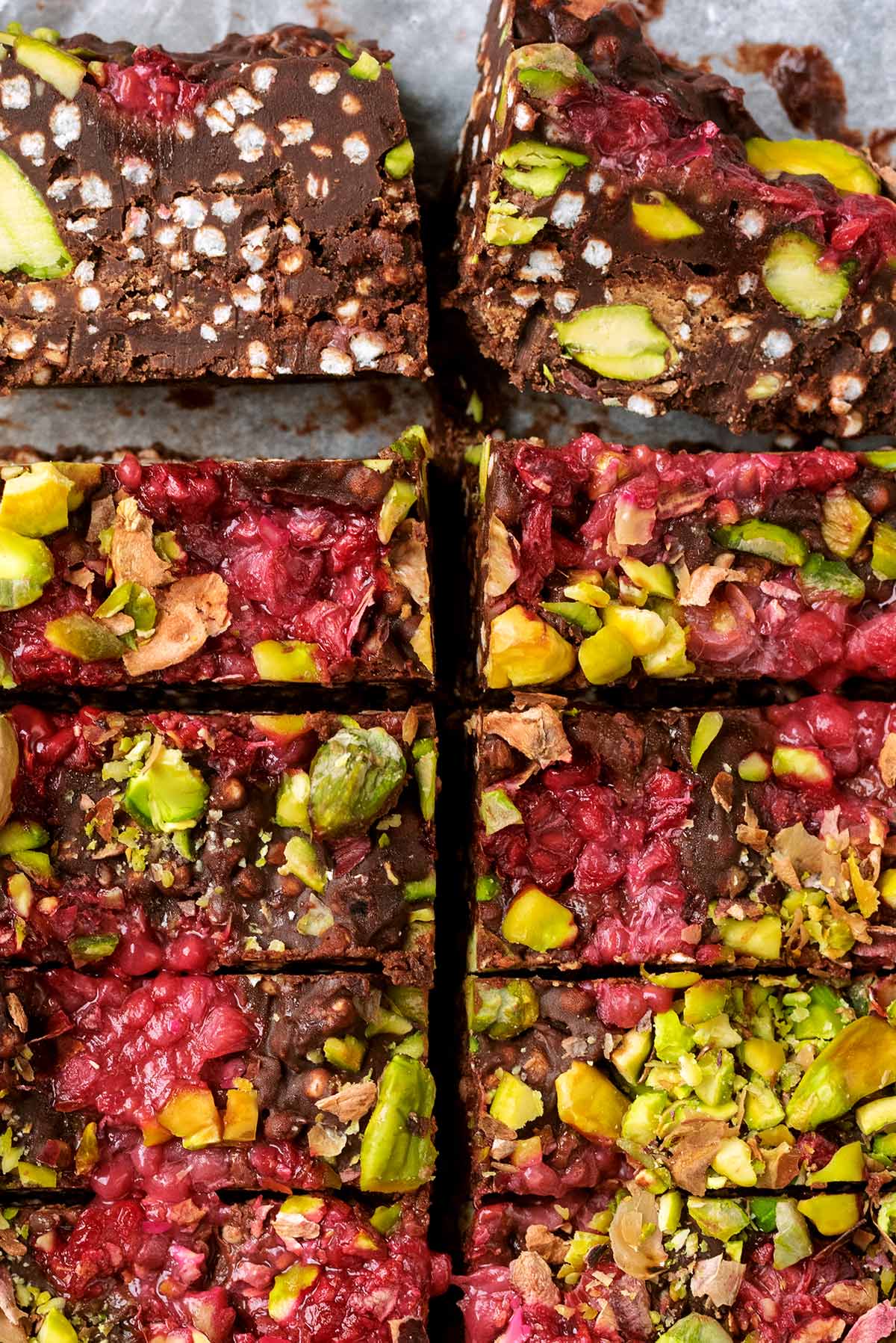 Ten chocolate fudge bars with two laying on their side, showing the inside.