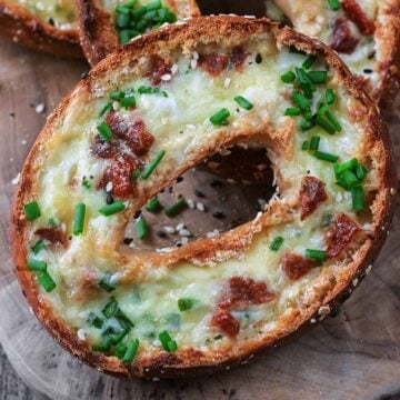 Breakfast bagel boats on a wooden board.