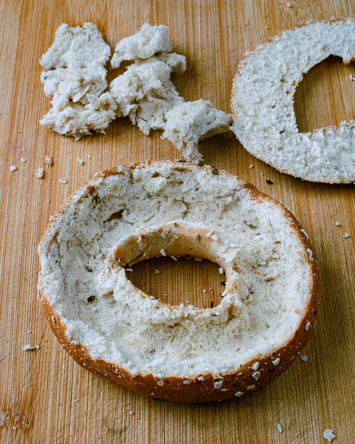 A bagel with the top sliced off and the bread centre removed.