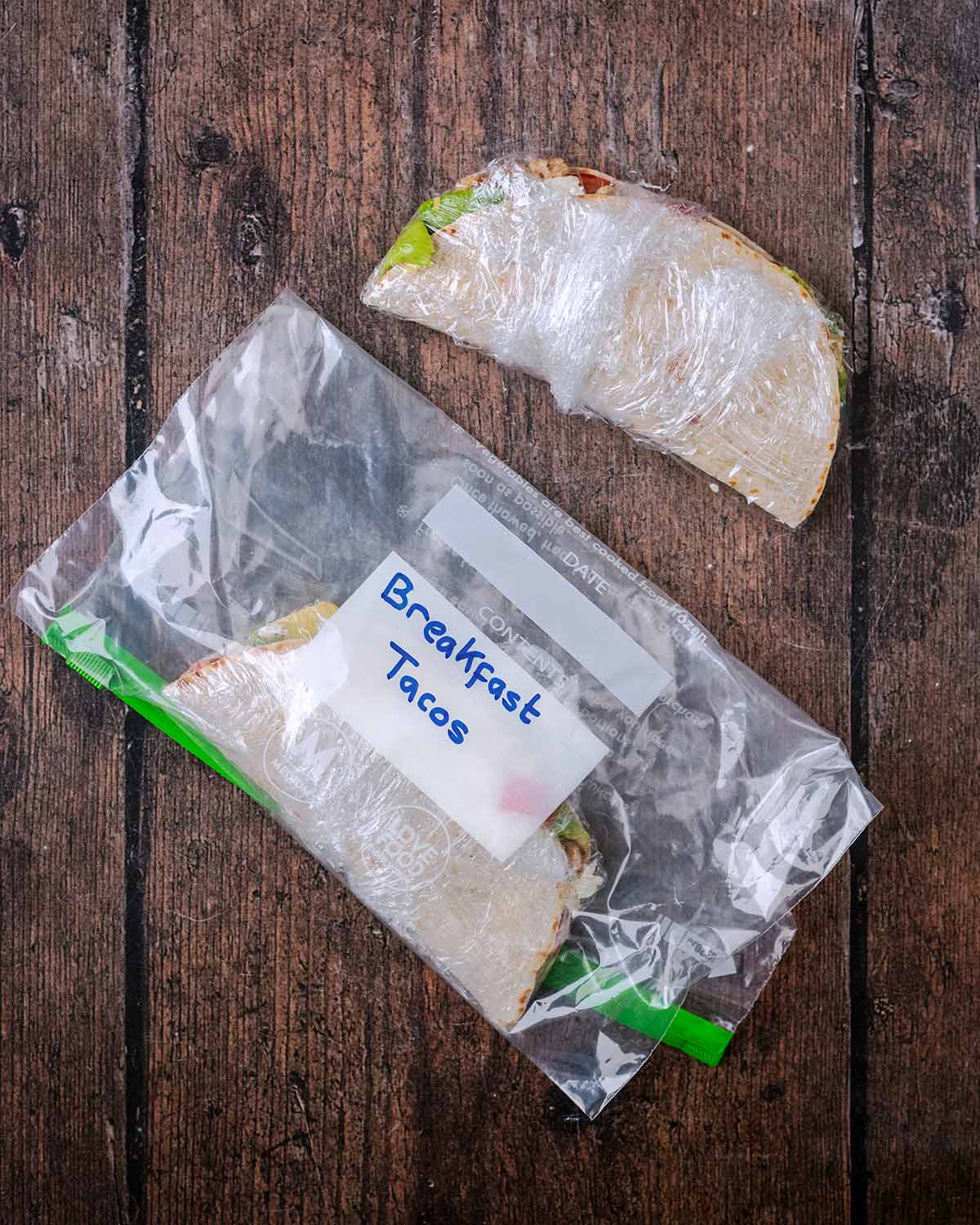 A breakfast taco wrapped in plastic wrap and put into a Ziploc bag.