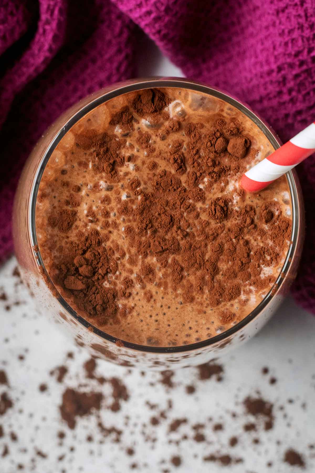 Cocoa powder sprinkled on top of a chocolate milkshake.