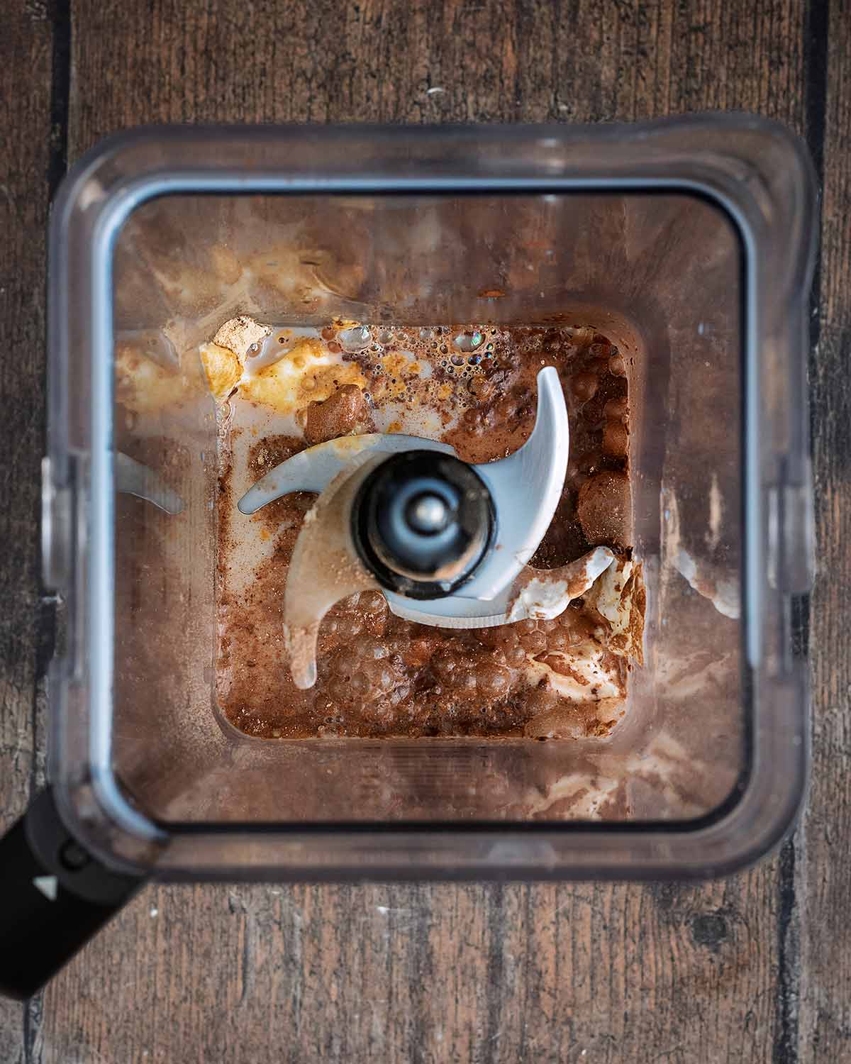 Chocolate milkshake ingredients in a blender jug.