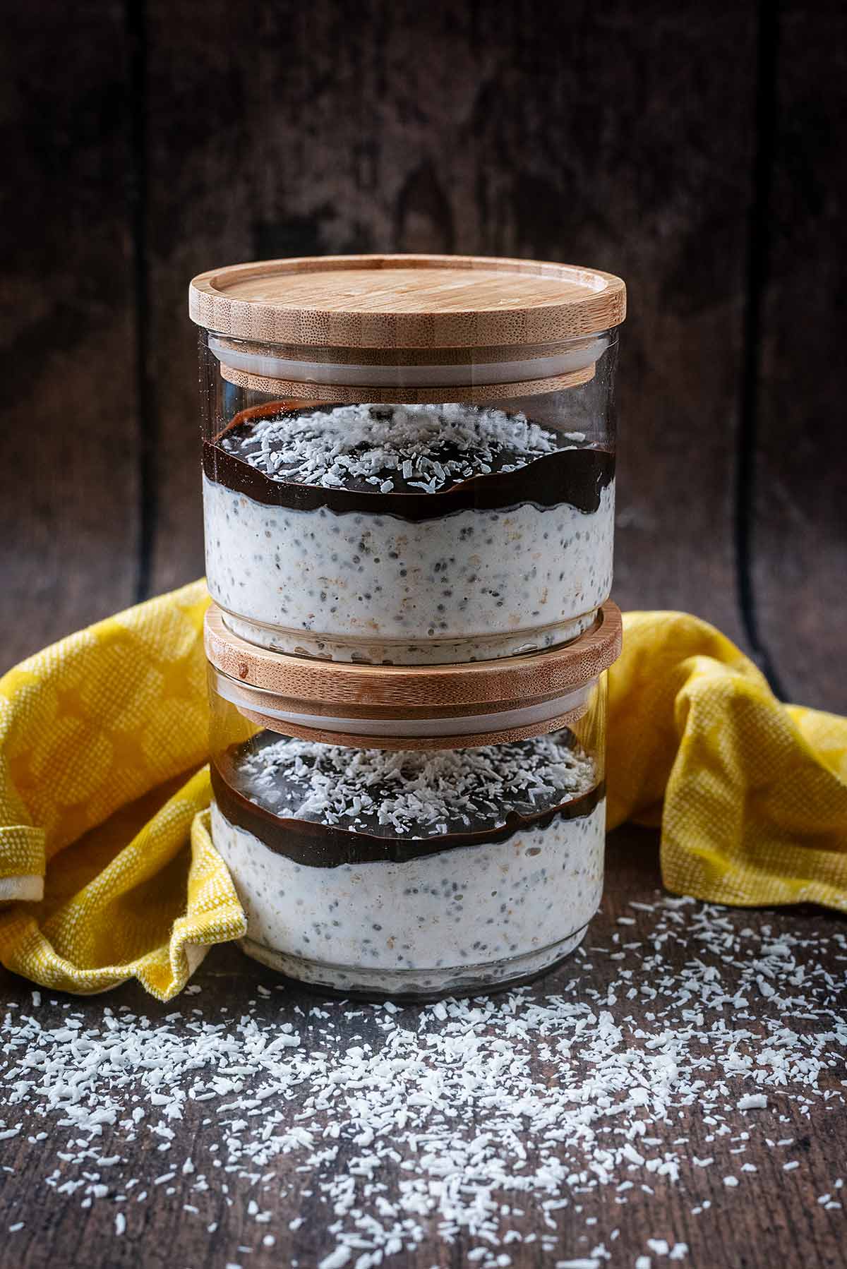 Chocolate and coconut topped overnight oats in two glass jars.