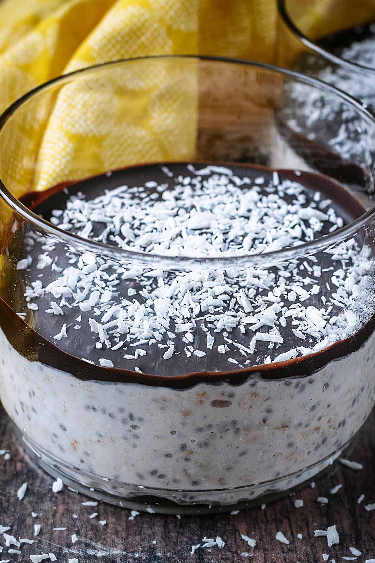 Desiccated coconut on top of a layer of chocolate on top of overnight oats.