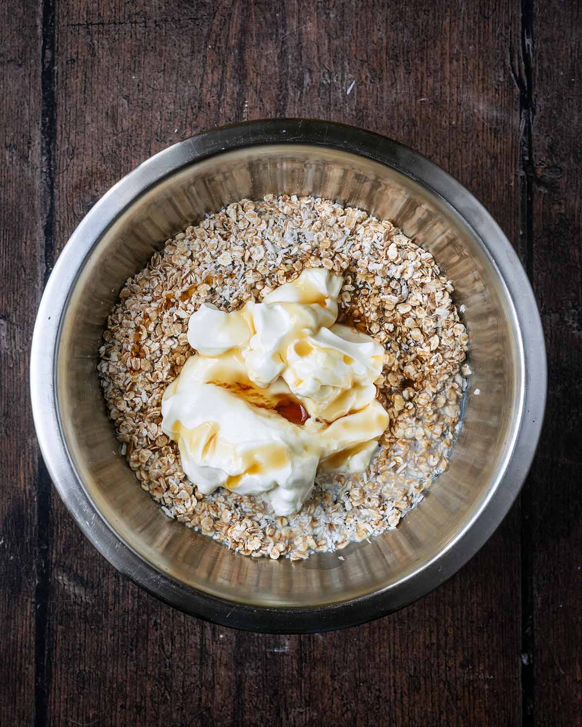 Yogurt and maple syrup added to the bowl.