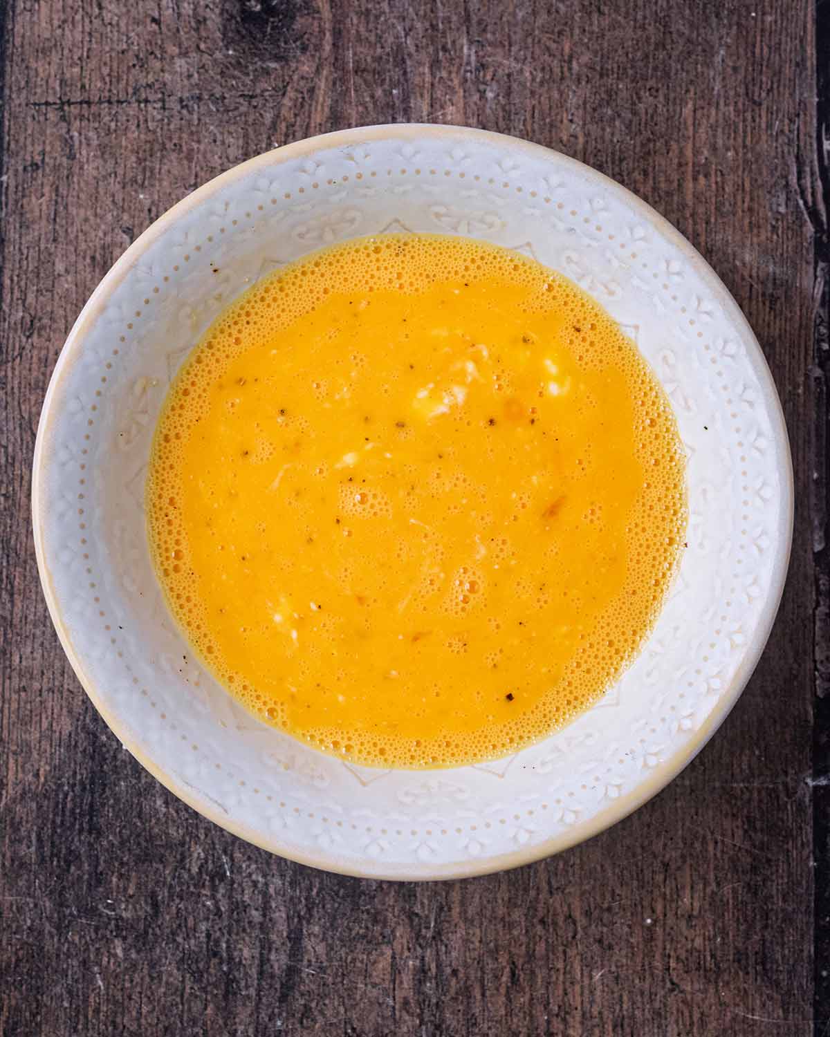 Eggs and cottage cheese combined in a bowl.