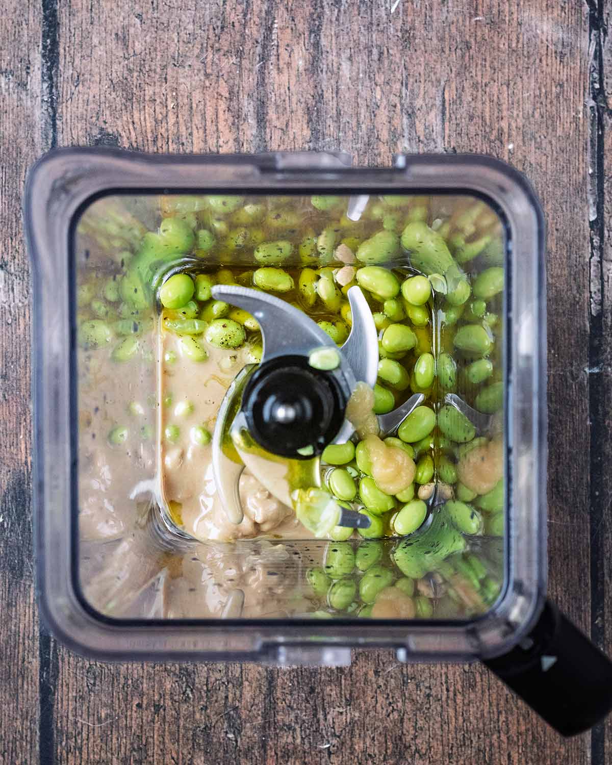 Edamame beans, tahini and garlic in a food processor.