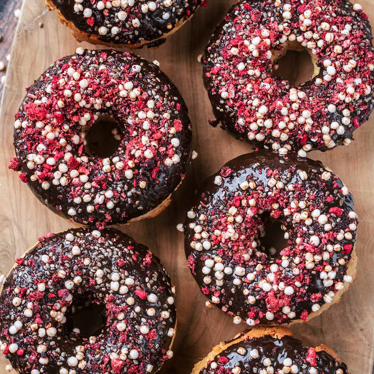 Baked donuts topped with chocolate and sprinkles.