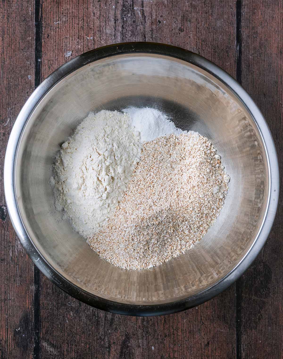 White flour, oat flour, baking powder and salt in a large metal mixing bowl.