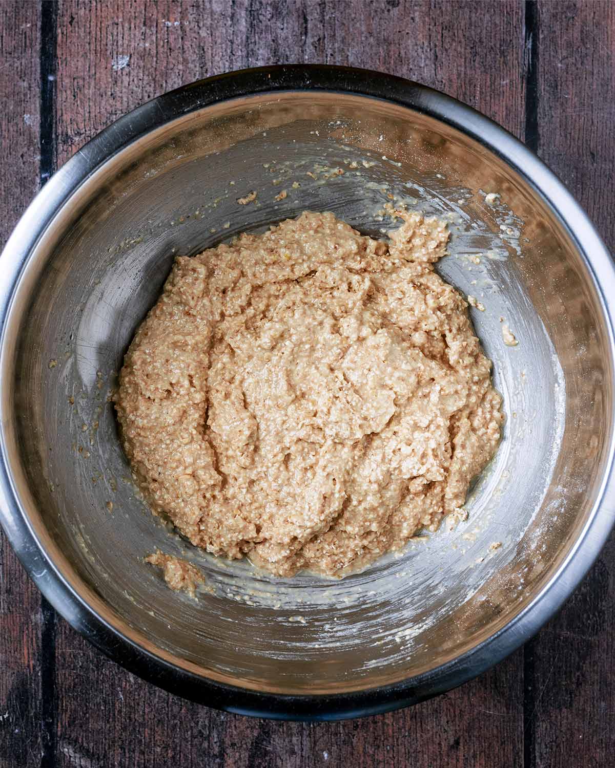 The dry ingredients combined with the wet ingredients in a mixing bowl.