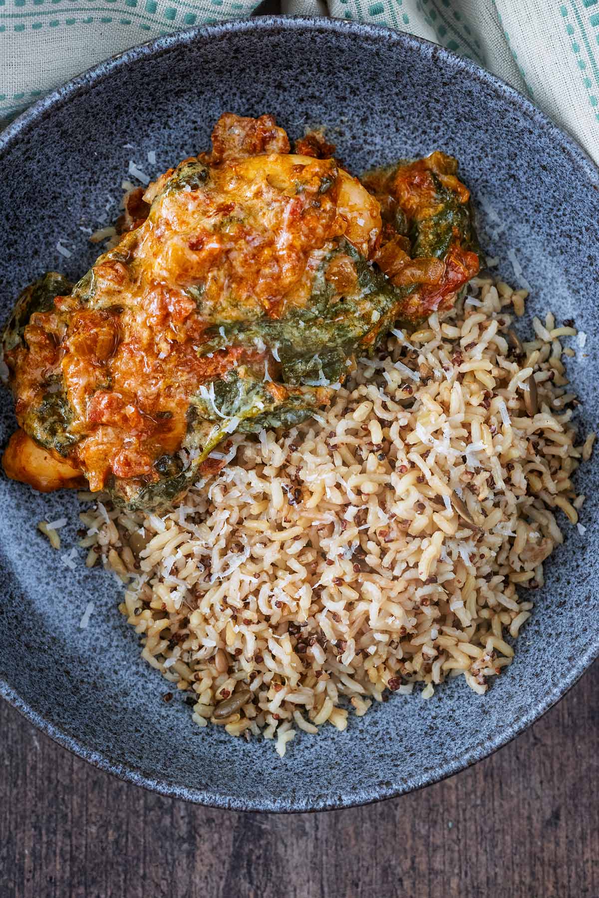 A bowl of creamy tomato chicken and rice.