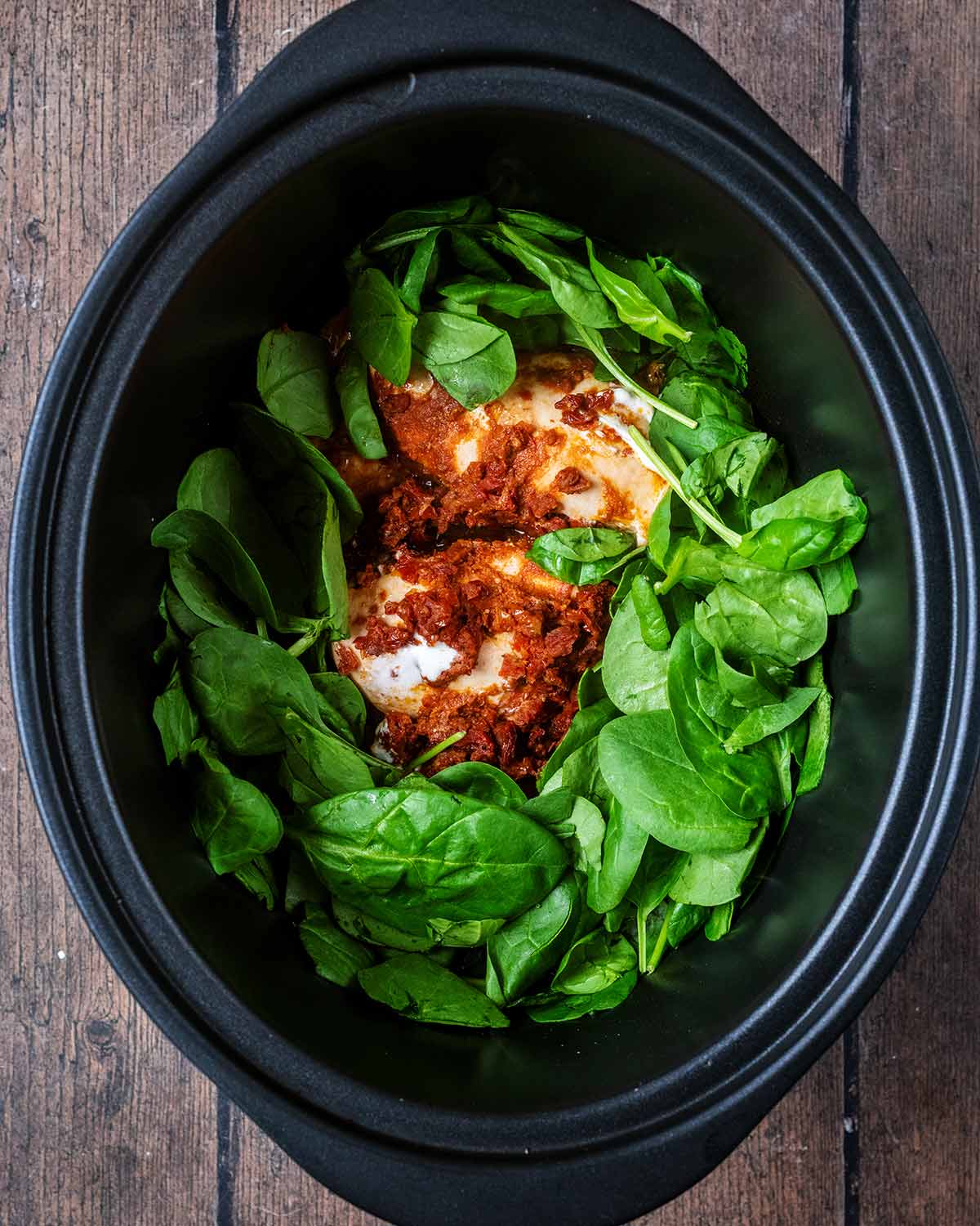 Spinach added to the slow cooker.