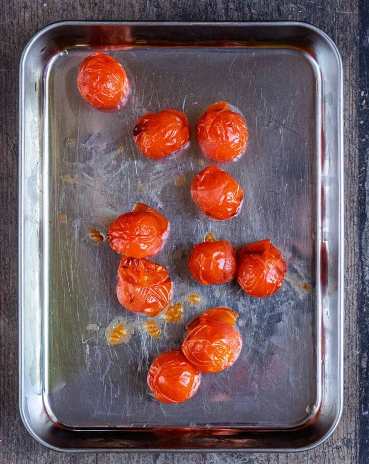 Roasted tomatoes on the baking tray.