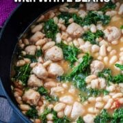 White bean and sausage skillet with a text overlay title.
