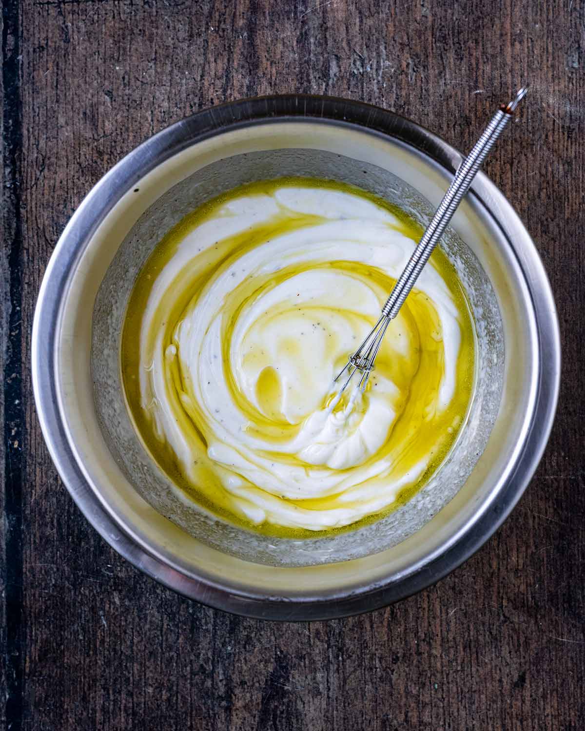 Yogurt, lemon juice and oil in a mixing bowl.