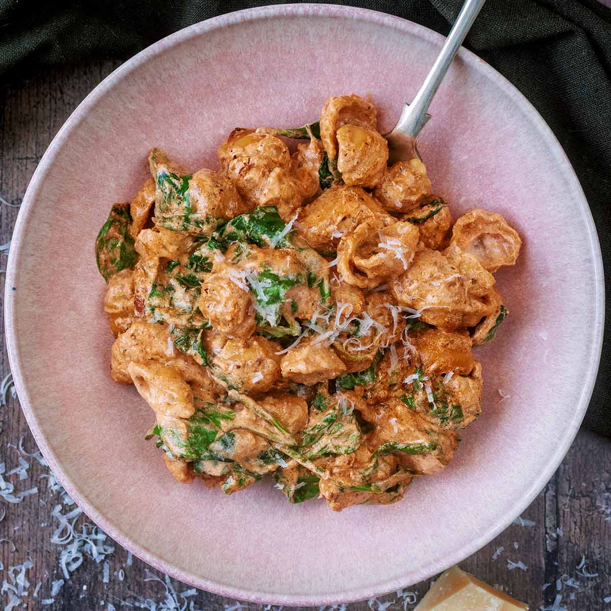 High protein marry me chicken in a round pink bowl.