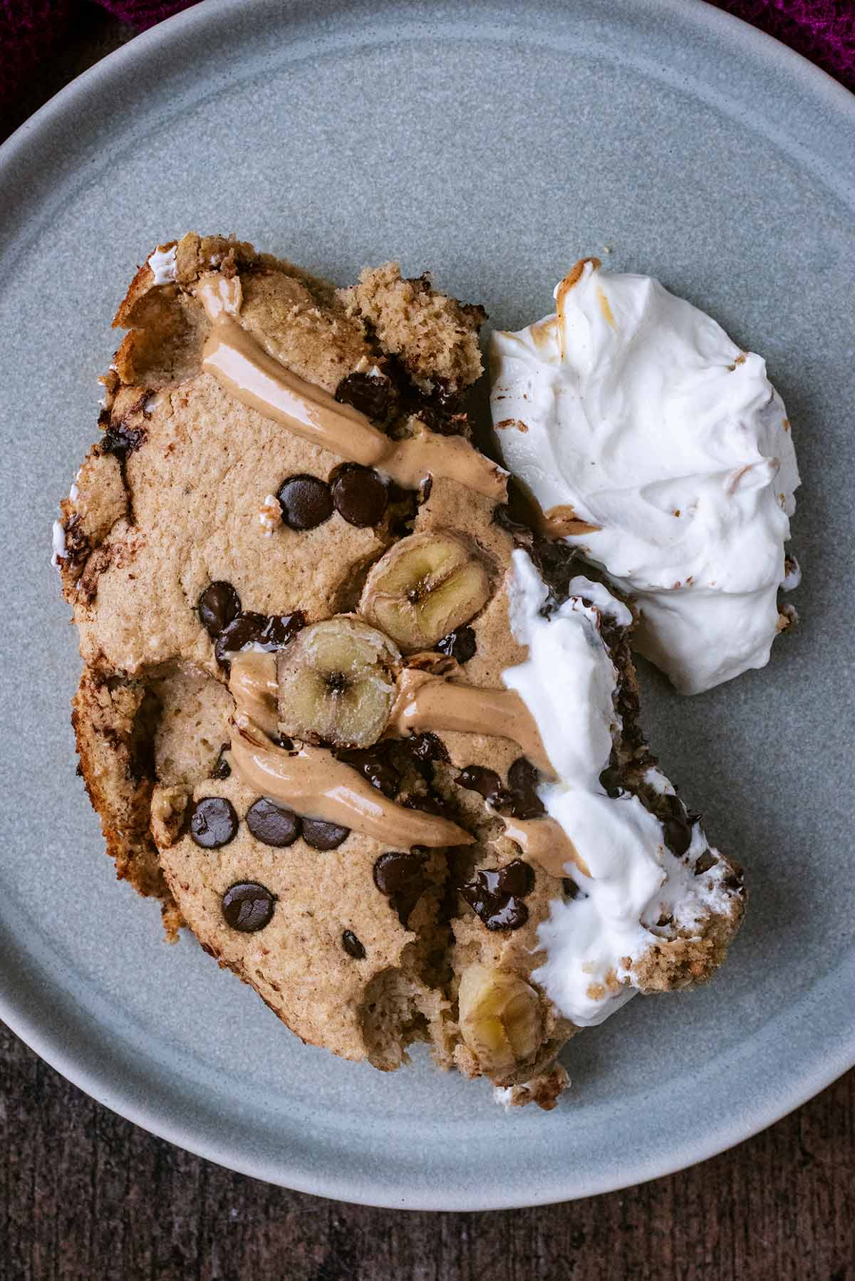 Baked oats on a plate with Greek yogurt and peanut butter.