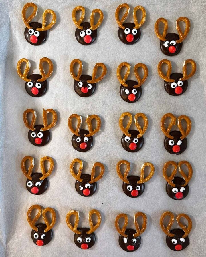 Melted chocolate buttons decorated with pretzel antlers, edible eyes and a Smartie nose.