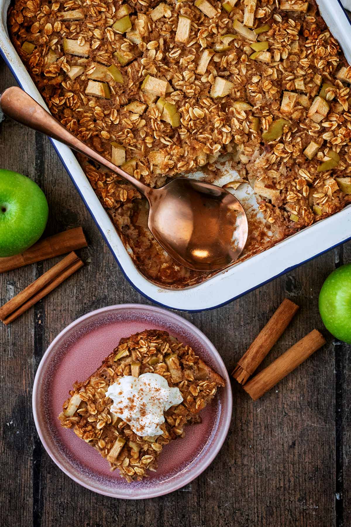 A baking dish of baked oats with a portion removed and on a plate.