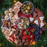 Christmas Snack Board surrounded by green garland.