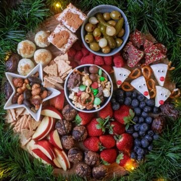 Christmas Snack Board surrounded by green garland.
