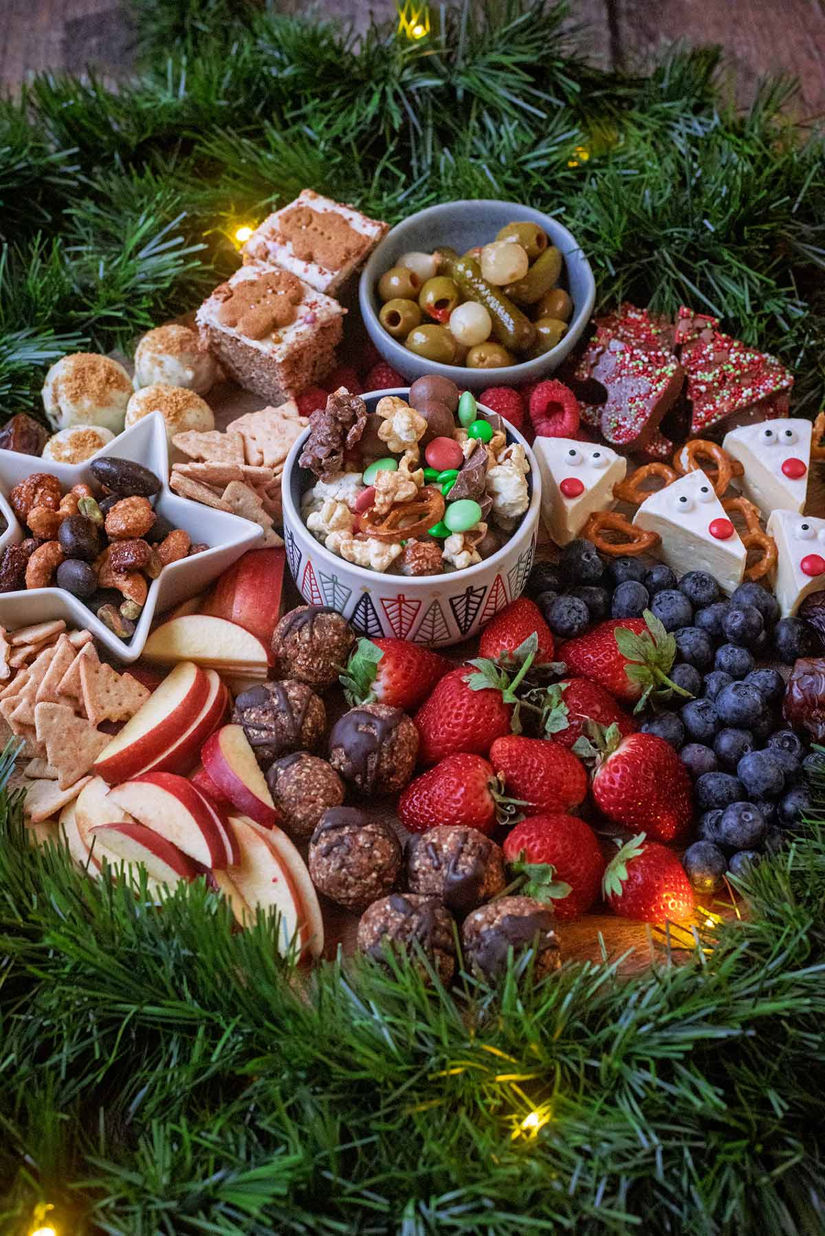 Bowls of snacks surrounded by other sweet and savoury snacks.