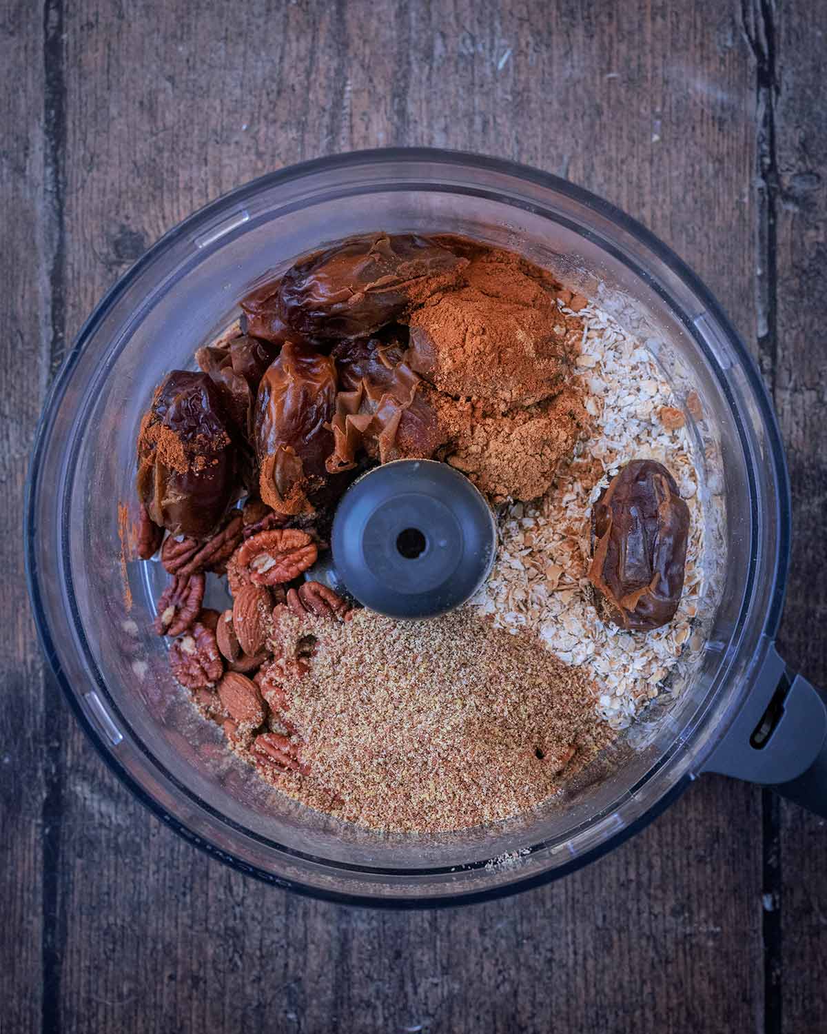 Dates, oats, seeds and spices in a food processor.