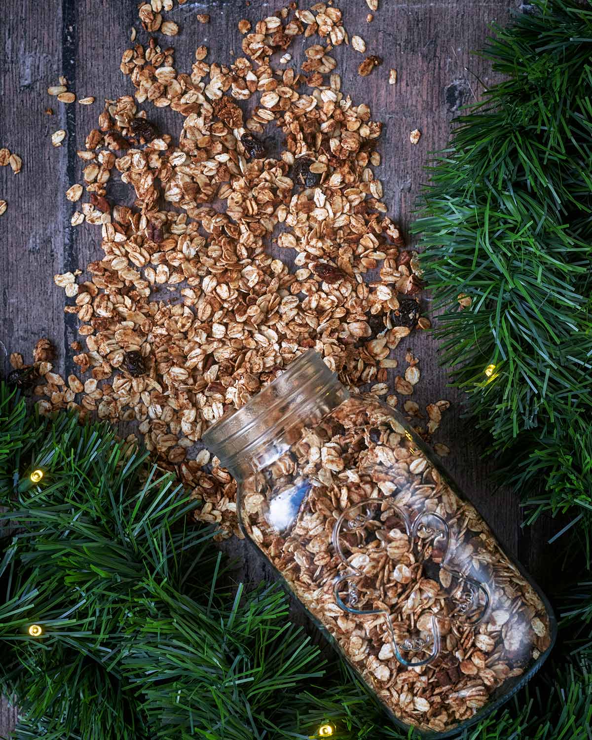 A glass jar laying down with granola spilling out of it.