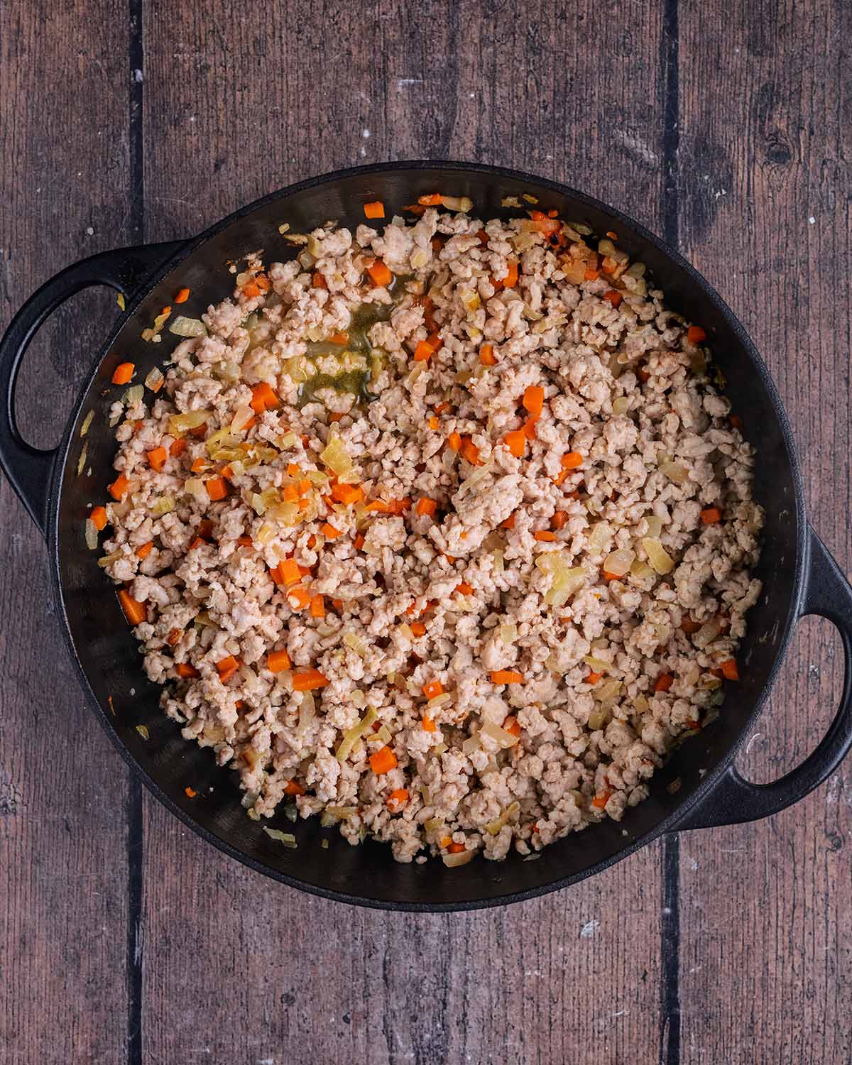 Cooked ground chicken added to the pan.