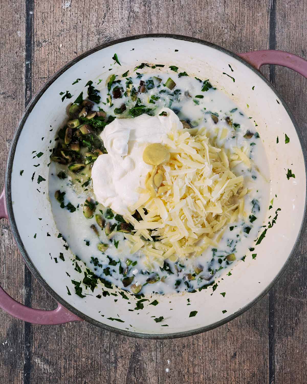 Milk, cheese and cream added to the pan.