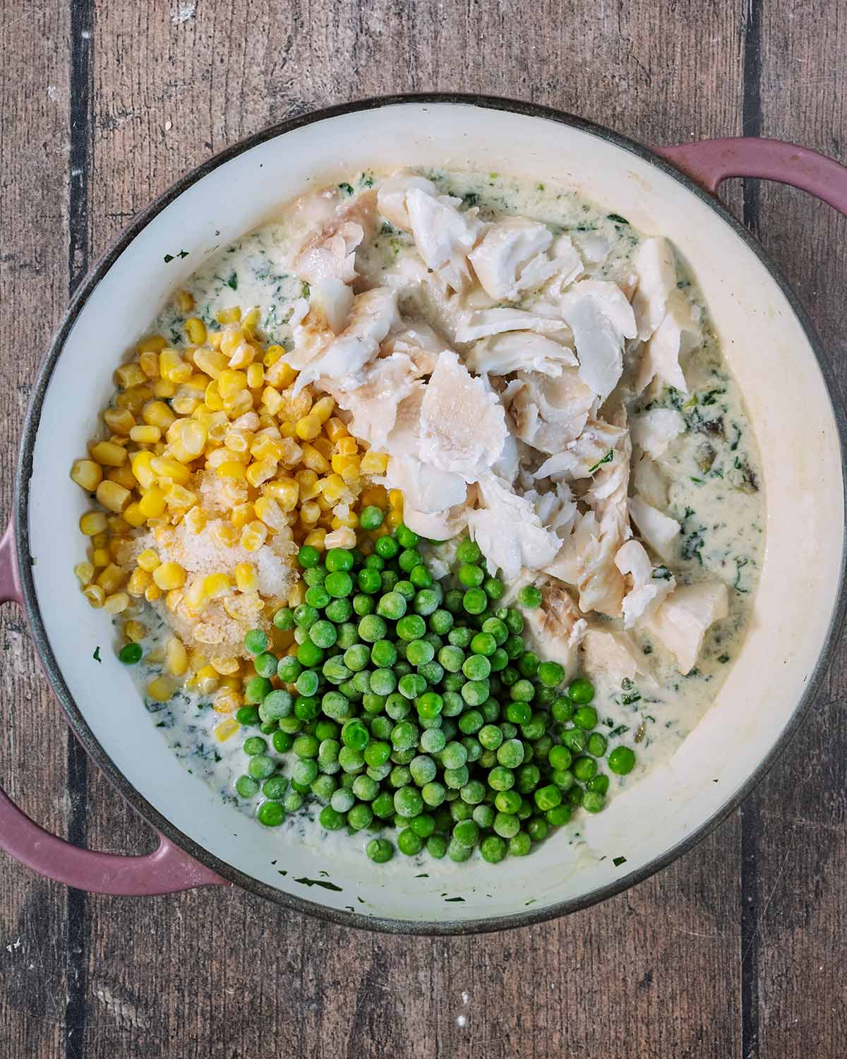 Flaked fish, peas and sweetcorn added to the pan.
