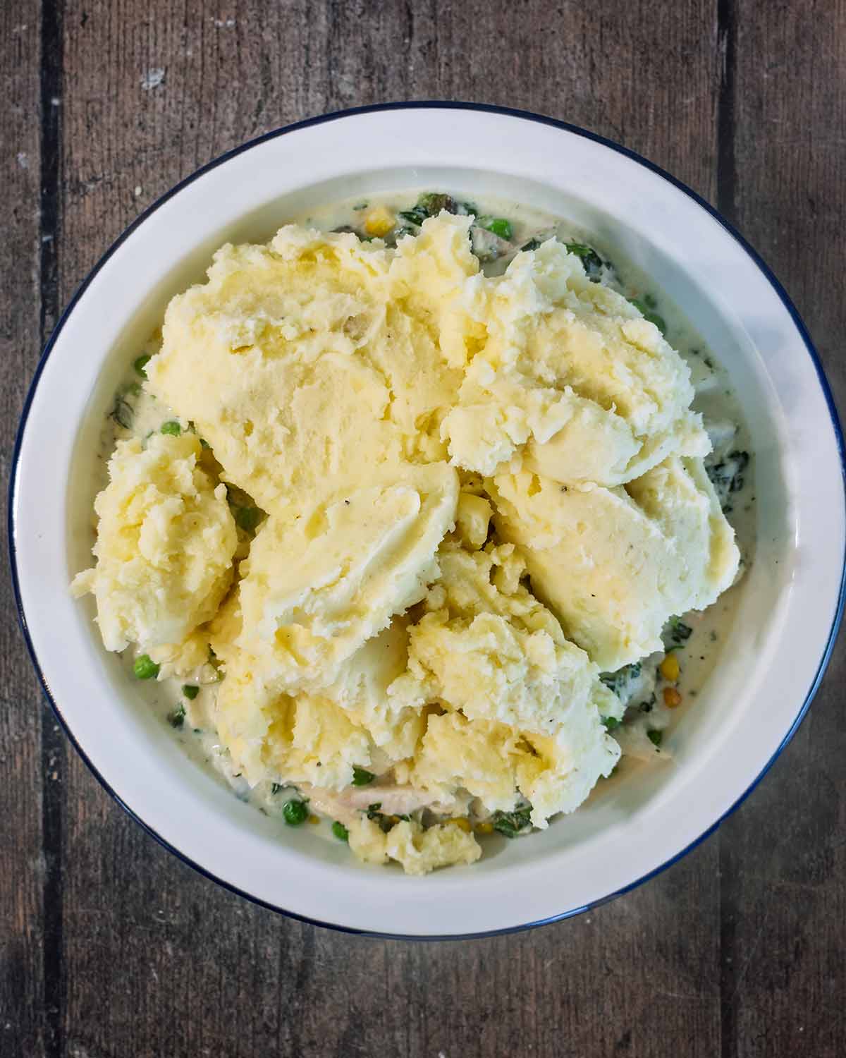 A large dollop of mashed potato put on top of the fish mixture.