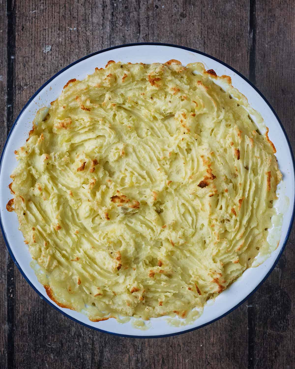 Baked fish pie in a round baking dish.