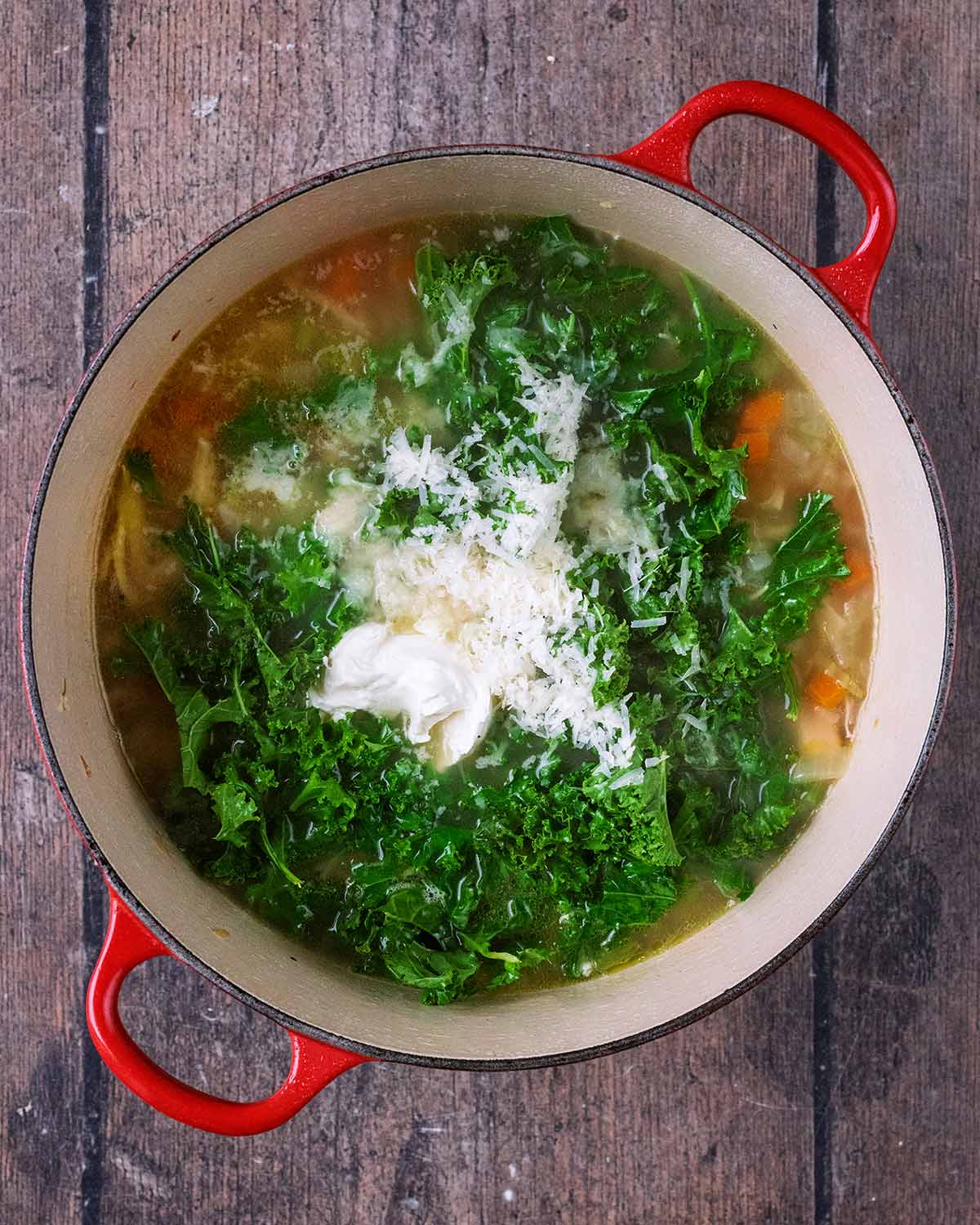 Kale, cream cheese and grated Parmesan added to the pan.