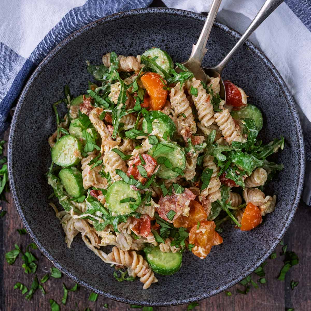 Chicken pesto pasta salad in a round grey bowl.