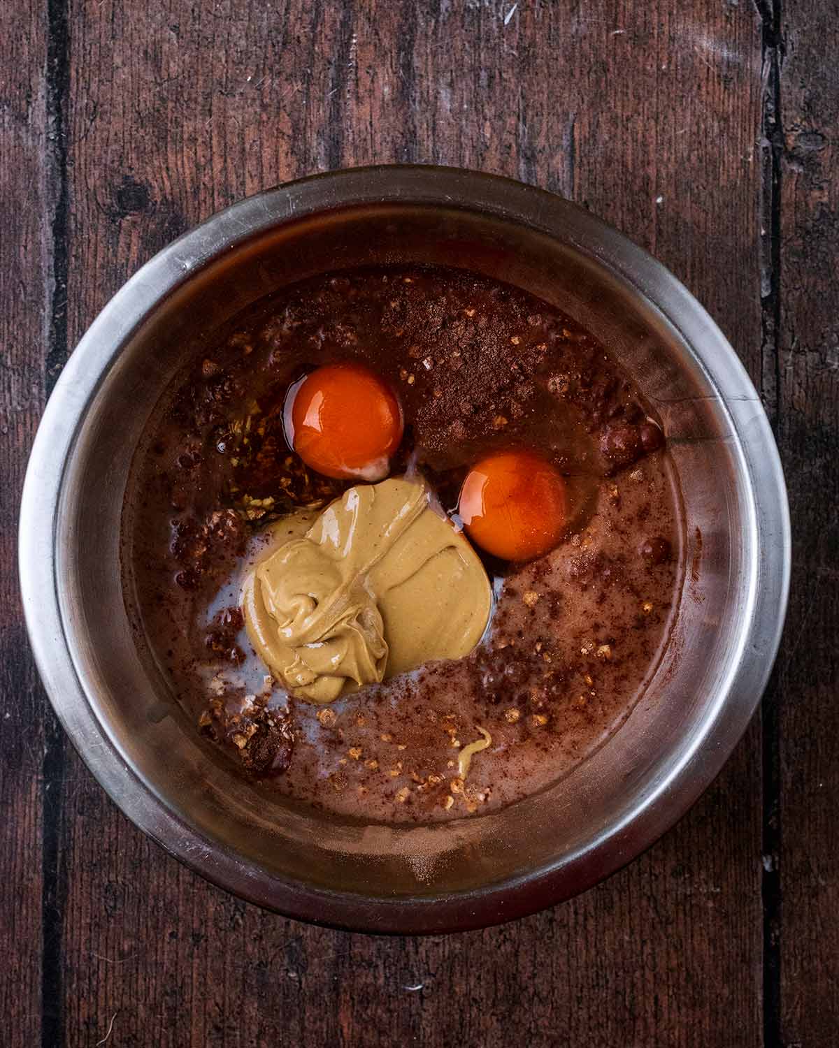 Milk, eggs and nut butter added to the bowl.