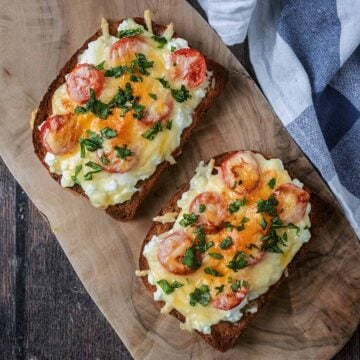 Two slices of cottage cheese grilled cheese on a wooden board.