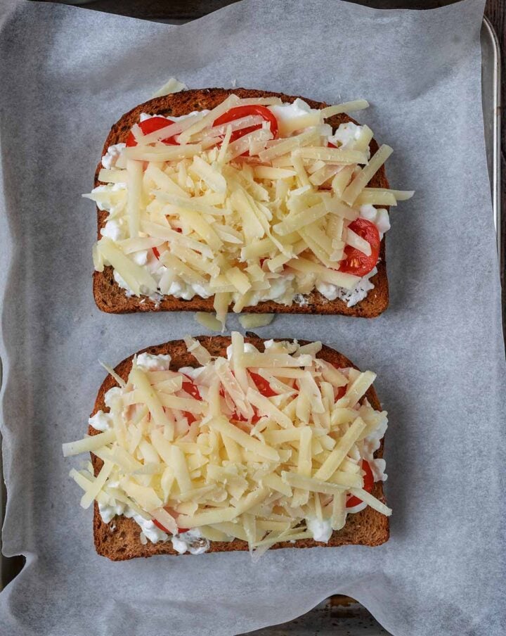 Grated cheddar added to the toast.
